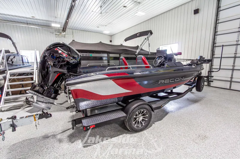 Slide: The Image of 2026 Recon 895 SC boat in showroom, featuring sleek design and powerful outboard motor. - 3
