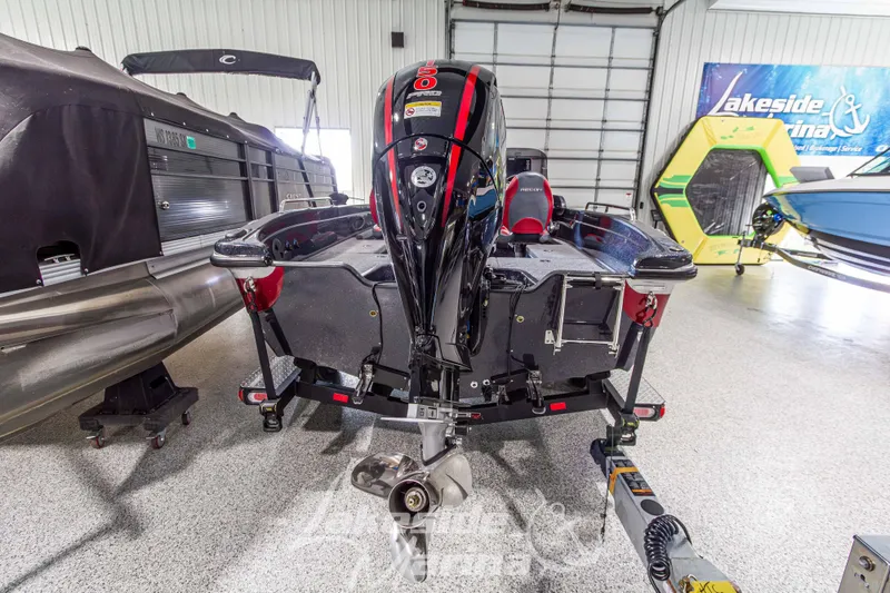 Slide: The Image of 2026 Recon 895 SC boat in showroom, featuring sleek design and powerful outboard motor. - 5