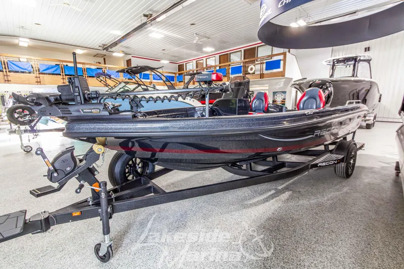 Slide: The Image of 2026 Recon 895 SC boat displayed in a showroom, featuring sleek design and modern equipment. - 7