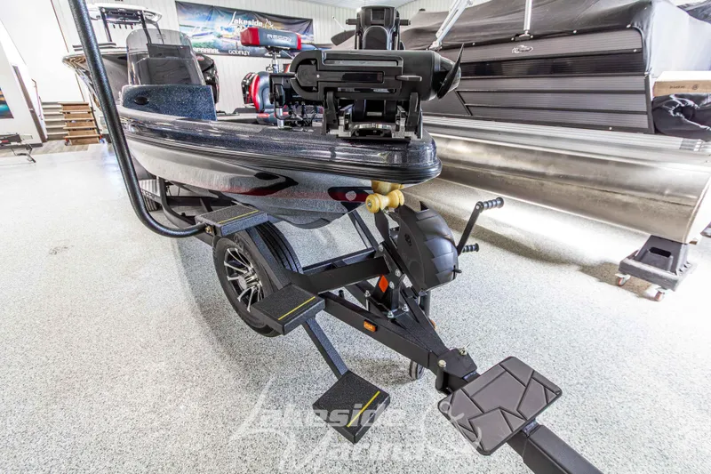 Slide: The Image of 2026 Recon 895 SC boat on trailer in showroom, showcasing sleek design and modern features. - 8