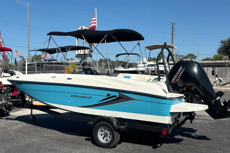 Slide: The Image of 2021 Bayliner Element E18 boat with Mercury engine on trailer, outdoors. - 1