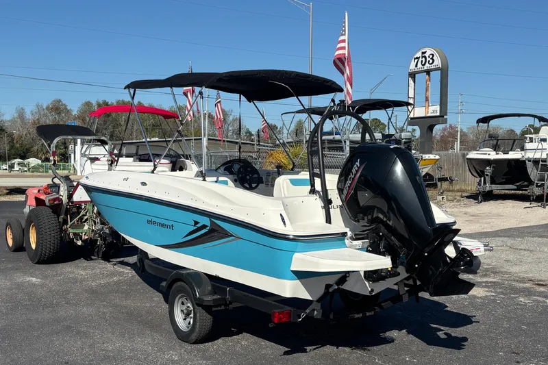 Slide: The Image of 2021 Bayliner Element E18 boat with Mercury engine on trailer, outdoor display. - 2