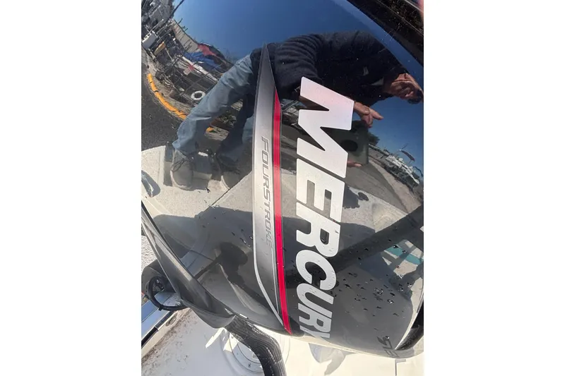 Slide: The Image of Mercury FourStroke engine on 2021 Bayliner Element E18 boat, reflecting surroundings. - 22
