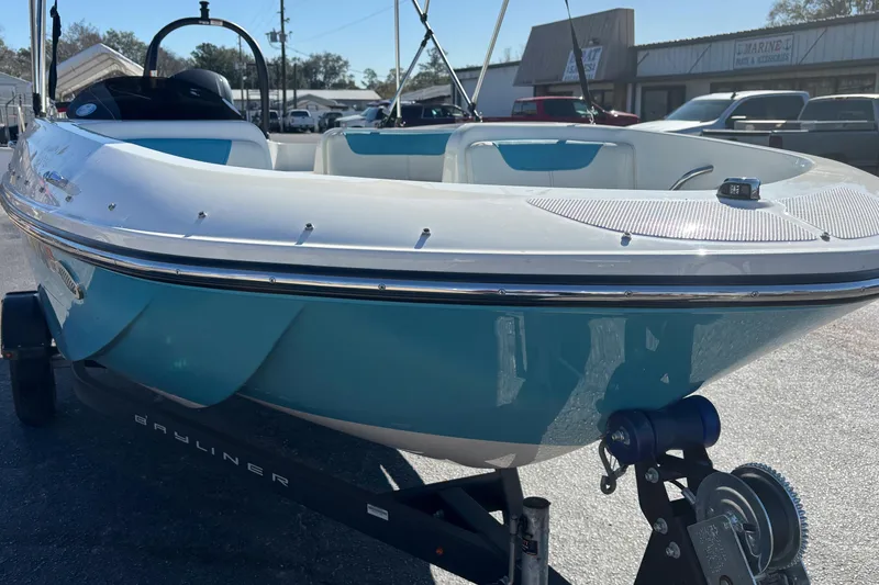 Slide: The Image of 2021 Bayliner Element E18 boat on trailer, blue and white exterior, parked outdoors. - 6