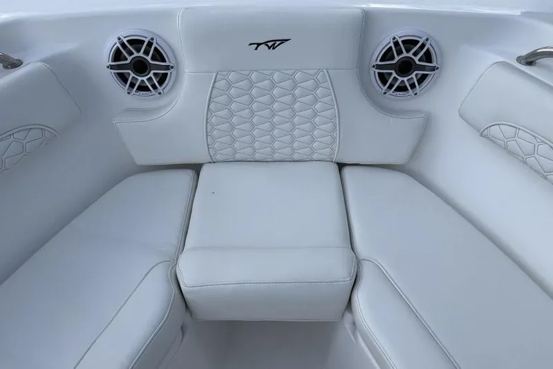 Slide: The Image of 2026 Tidewater 232 LXF boat interior with white cushioned seating and speakers. - 10
