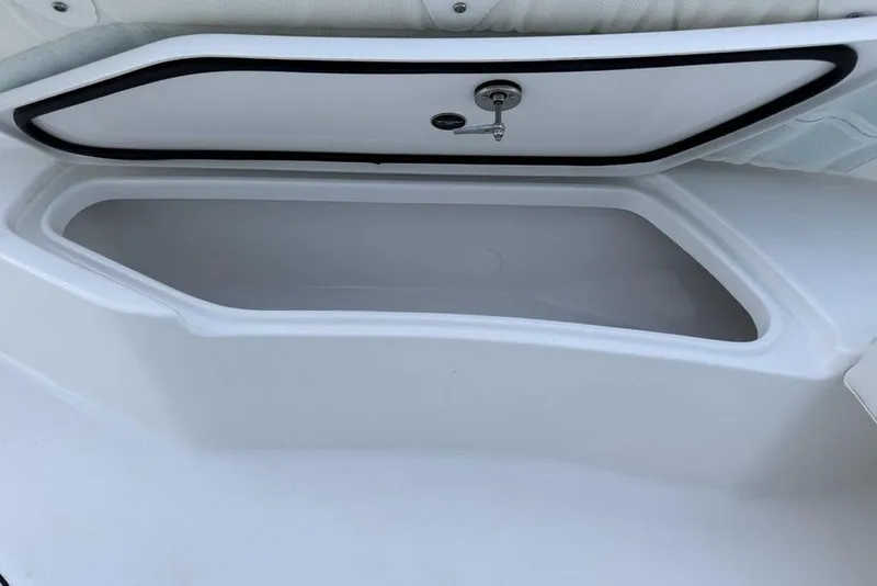 Slide: The Image of Storage compartment on 2026 Tidewater 232 LXF boat, featuring sleek design and secure latch. - 11