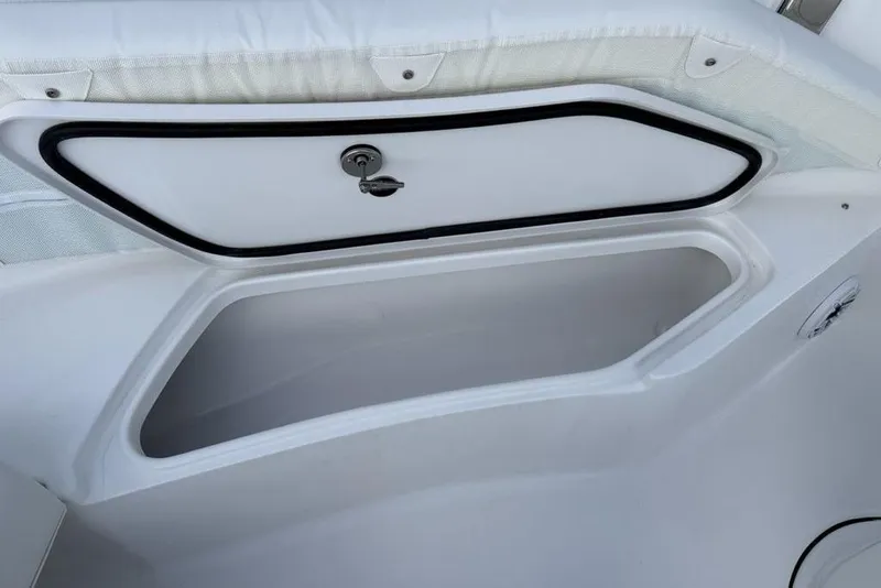 Slide: The Image of Storage compartment on a 2026 Tidewater 232 LXF boat, featuring a secure latch. - 12