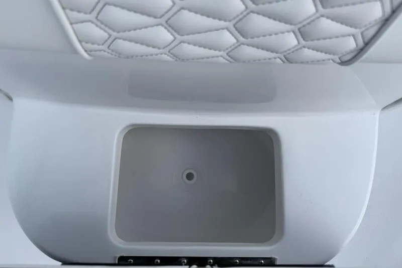 Slide: The Image of 2026 Tidewater 232 LXF boat interior with quilted upholstery and storage compartment. - 13