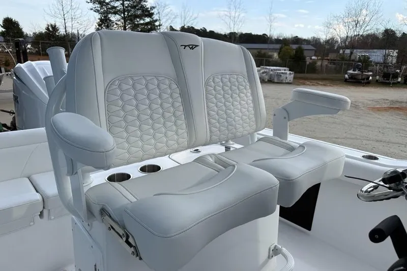 Slide: The Image of 2026 Tidewater 232 LXF boat with luxurious white seating and armrests. - 17