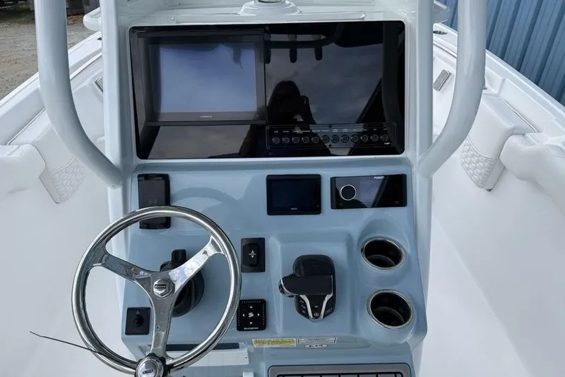 Slide: The Image of 2026 Tidewater 232 LXF boat console with steering wheel and electronic displays. - 18