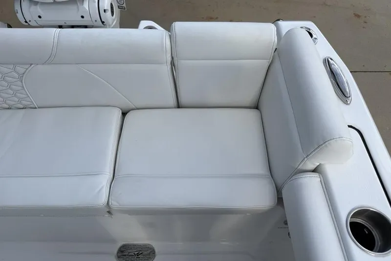 Slide: The Image of White seating area on 2026 Tidewater 232 LXF boat, featuring cup holders and sleek design. - 19