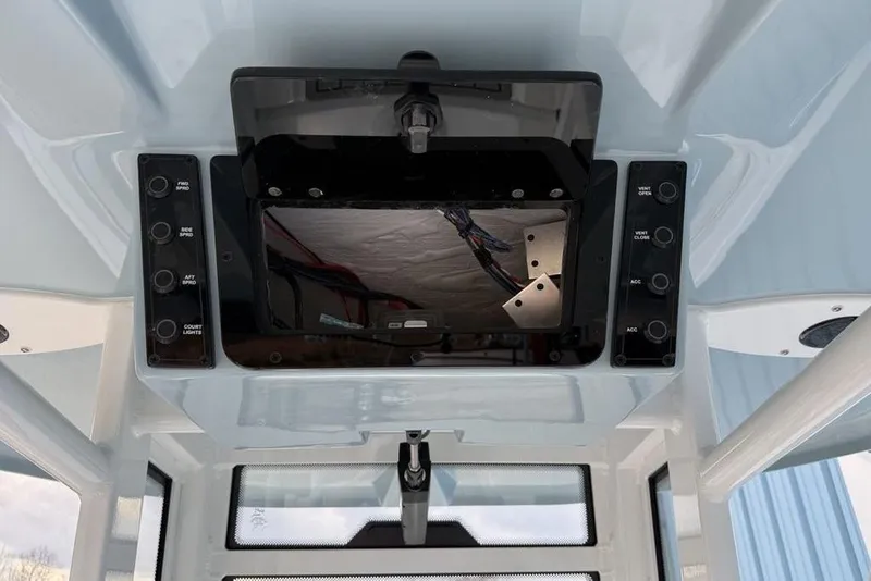 Slide: The Image of Control panel of 2026 Tidewater 232 LXF boat, featuring various switches and a display. - 20