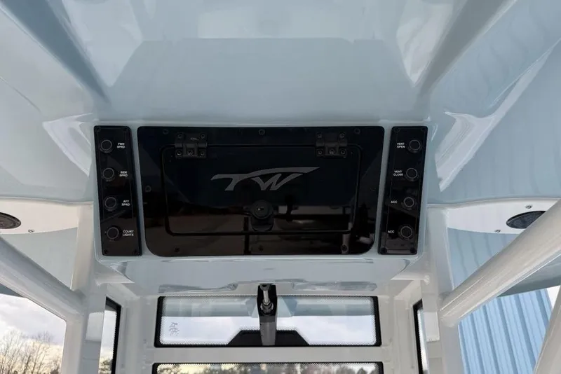 Slide: The Image of 2026 Tidewater 232 LXF boat console with control panel and logo. - 22