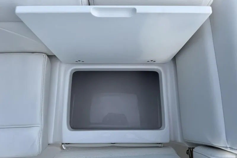 Slide: The Image of 2026 Tidewater 232 LXF boat storage compartment with open lid, showcasing interior space. - 23
