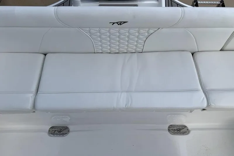 Slide: The Image of 2026 Tidewater 232 LXF boat with white cushioned seating and logo detail. - 24