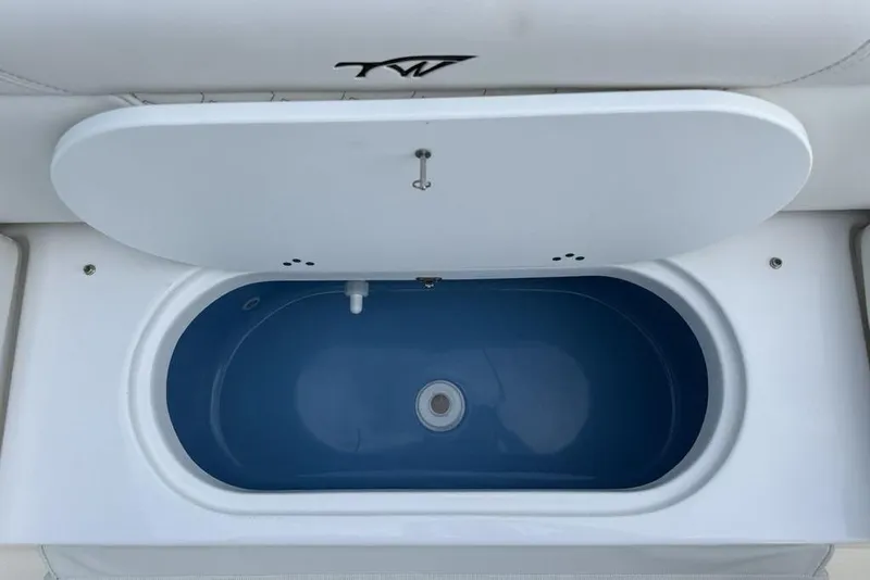 Slide: The Image of Livewell compartment on 2026 Tidewater 232 LXF boat, featuring a sleek blue interior. - 25
