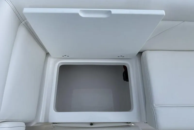 Slide: The Image of 2026 Tidewater 232 LXF boat storage compartment with open lid, showcasing interior space. - 27