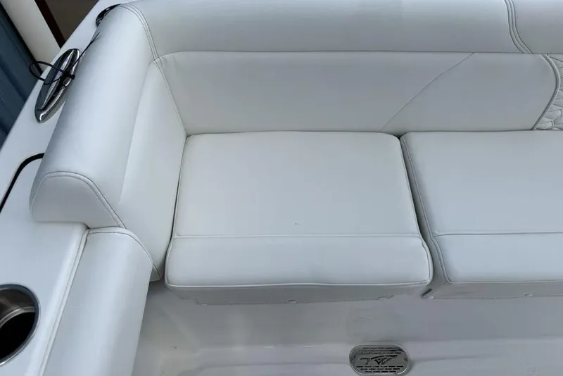 Slide: The Image of 2026 Tidewater 232 LXF boat with white cushioned seating and stainless steel cup holder. - 28