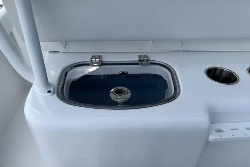 Slide: The Image of 2026 Tidewater 232 LXF boat livewell and cup holders on deck. - 29
