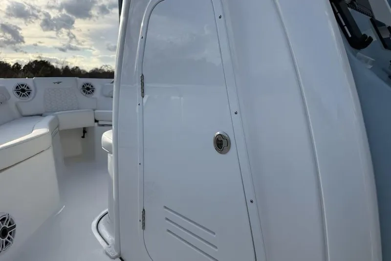 Slide: The Image of 2026 Tidewater 232 LXF boat interior with white seating and storage compartment. - 30