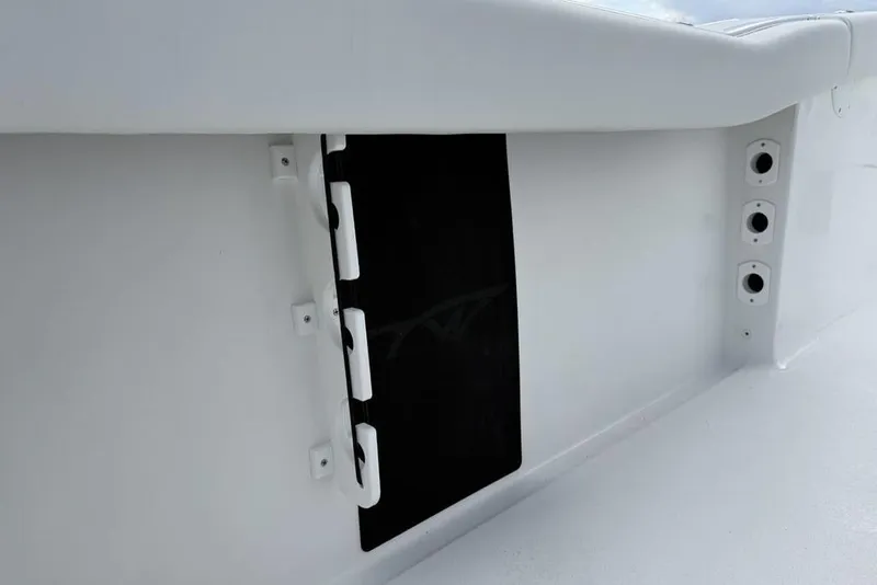 Slide: The Image of 2026 Tidewater 232 LXF boat interior detail with storage compartment and rod holders. - 31