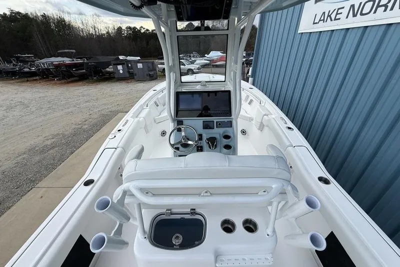 Slide: The Image of 2026 Tidewater 232 LXF boat interior with helm, seating, and rod holders. - 36