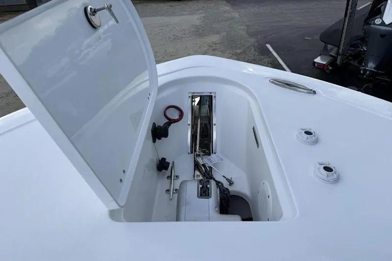 Slide: The Image of Open anchor compartment on 2026 Tidewater 232 LXF boat, showcasing storage and hardware. - 4