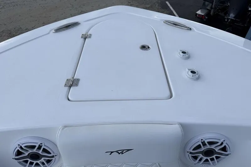 Slide: The Image of 2026 Tidewater 232 LXF boat deck with storage hatch and speakers. - 5