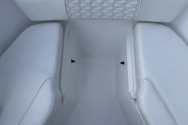 Slide: The Image of Interior seating of 2026 Tidewater 232 LXF boat, featuring white upholstery and hexagonal stitching. - 7