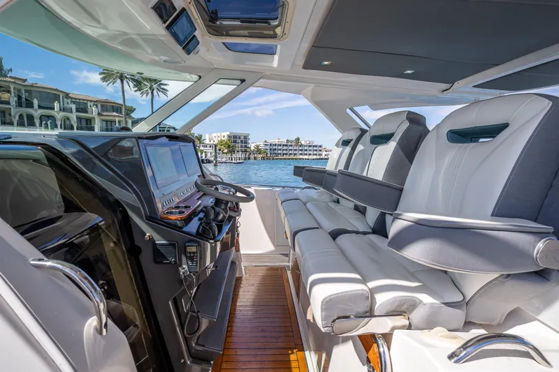 Slide: The Image of 2019 Tiara Sport 38 LS yacht interior with luxurious seating and modern dashboard. - 18