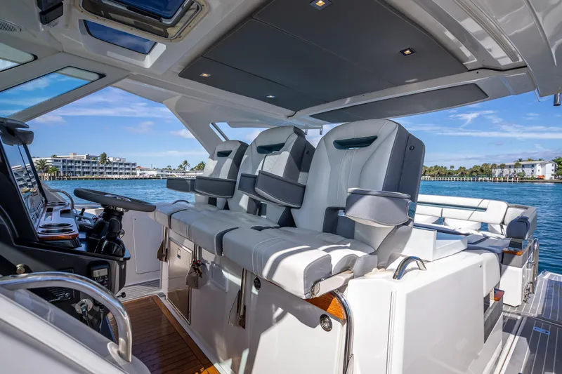 Slide: The Image of 2019 Tiara Sport 38 LS luxury yacht interior with plush seating and modern controls. - 19