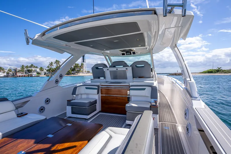 Slide: The Image of Luxurious 2019 Tiara Sport 38 LS yacht interior with seating, cruising on clear blue waters. - 28