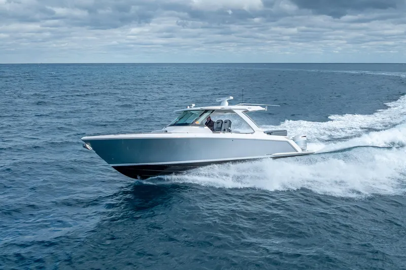 Slide: The Image of 2019 Tiara Sport 38 LS cruising on open ocean under cloudy skies. - 3