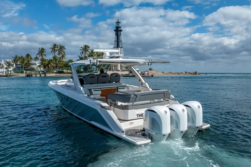 Slide: The Image of 2019 Tiara Sport 38 LS boat cruising near a lighthouse and palm trees. - 31