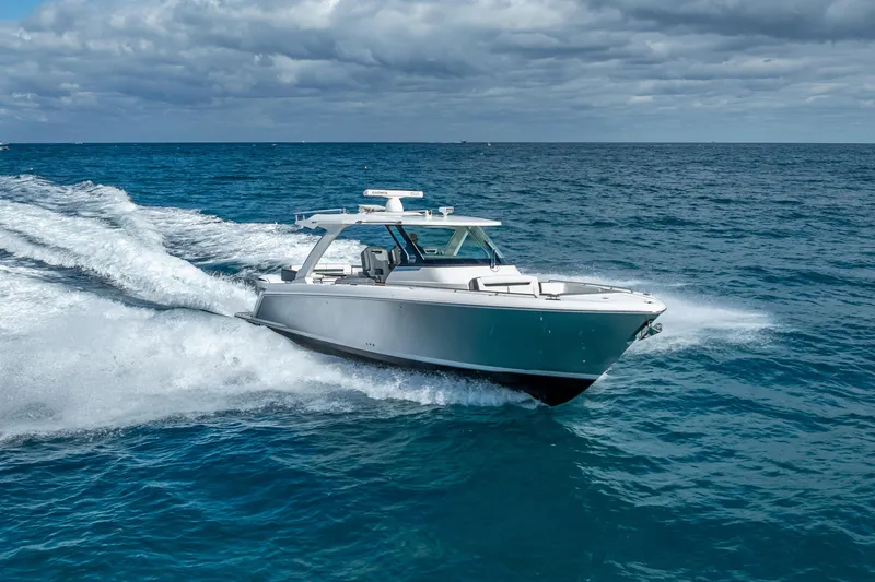 Slide: The Image of 2019 Tiara Sport 38 LS cruising on open ocean under cloudy sky. - 35