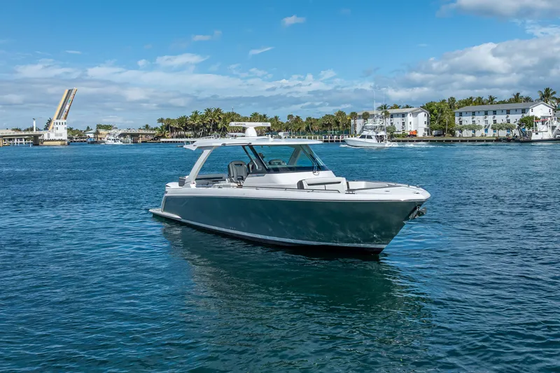 Slide: The Image of 2019 Tiara Sport 38 LS boat cruising on a sunny day near a drawbridge. - 36