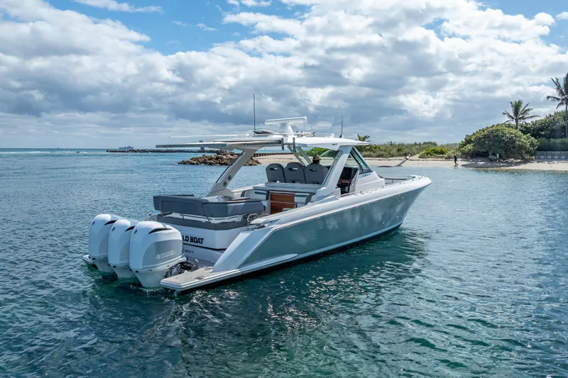 Slide: The Image of 2019 Tiara Sport 38 LS boat on calm water near a tropical shoreline. - 37