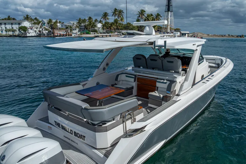 Slide: The Image of 2019 Tiara Sport 38 LS luxury boat docked in tropical waters, featuring sleek design and spacious seating. - 4