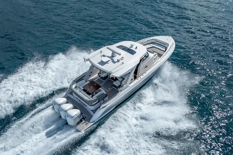 Slide: The Image of 2019 Tiara Sport 38 LS yacht cruising on open water, aerial view. - 8