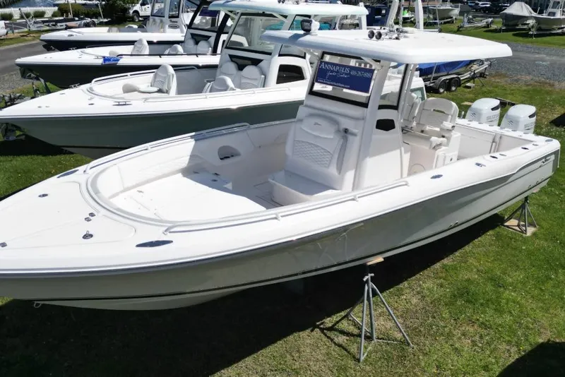 The Image of 2022 Stamas 31T Aventura boat displayed outdoors on grass, surrounded by other boats. - 1