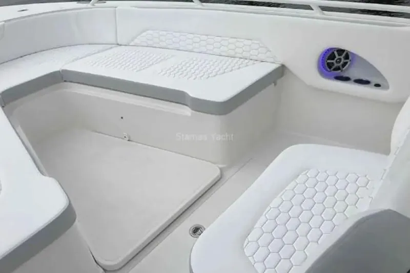 Slide: The Image of 2022 Stamas 31T Aventura boat interior with white cushioned seating and speaker system. - 10