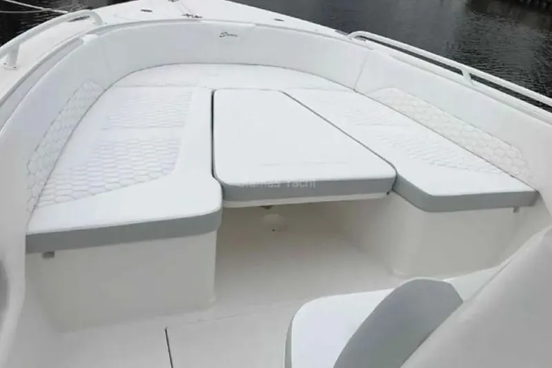 Slide: The Image of 2022 Stamas 31T Aventura boat interior with white cushioned seating. - 13