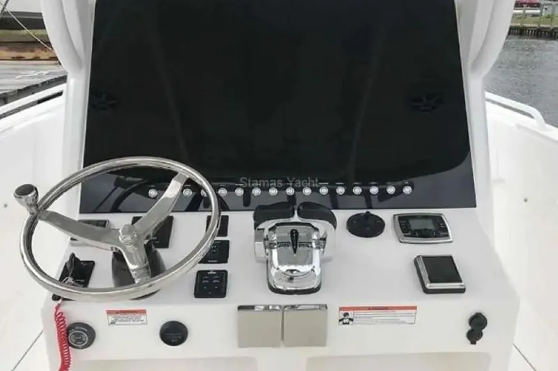 Slide: The Image of Control panel of 2022 Stamas 31T Aventura boat with steering wheel and navigation instruments. - 14