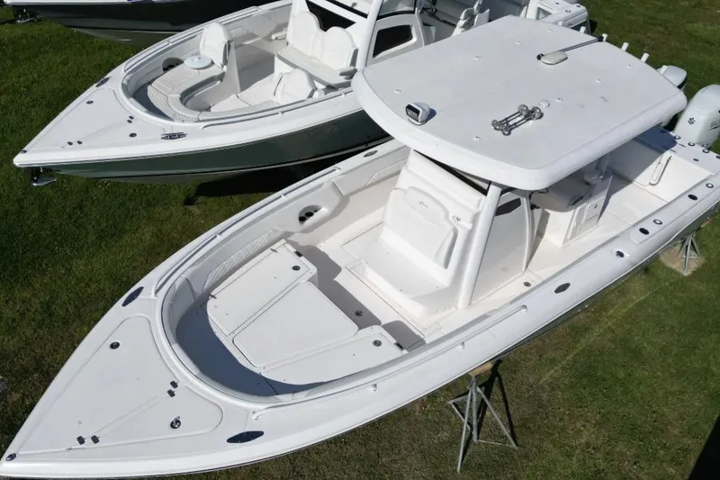 Slide: The Image of 2022 Stamas 31T Aventura boat on display, aerial view, white exterior, parked on grass. - 5