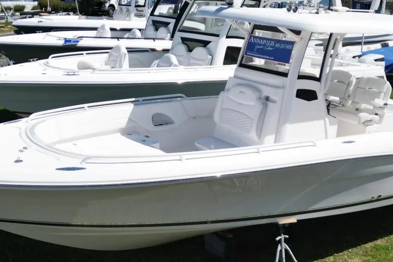 Slide: The Image of 2022 Stamas 31T Aventura boat displayed at a marina, showcasing sleek design and spacious seating. - 6