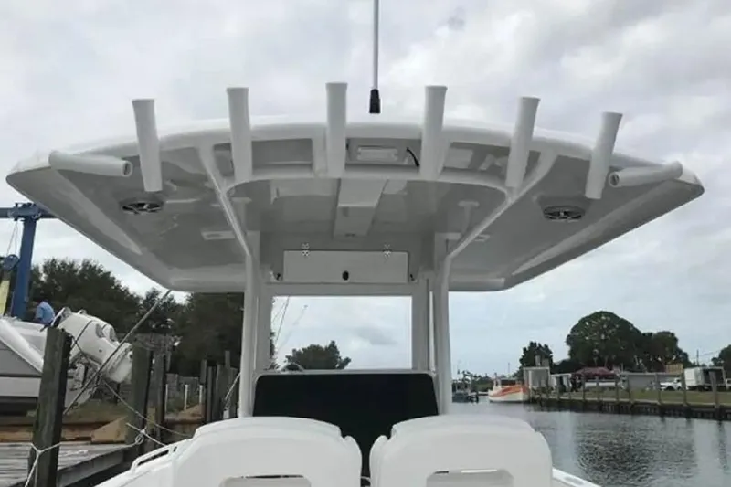 Slide: The Image of 2022 Stamas 31T Aventura boat with T-top and rod holders at a marina. - 8