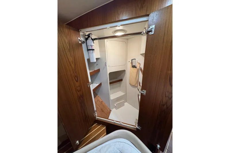 Slide: The Image of Interior of 2007 Tiara 43 yacht with wooden door and storage shelves. - 10