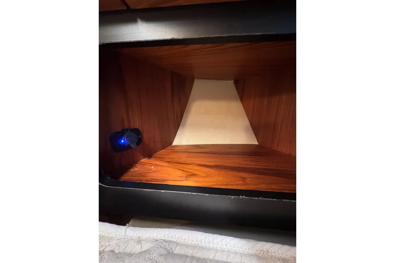 Slide: The Image of Interior view of a Tiara 43 (2007) with wooden paneling and a small blue light. - 11
