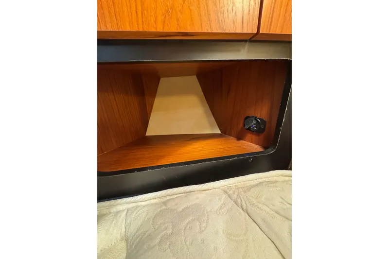 Slide: The Image of Wooden interior detail of a 2007 Tiara 43 boat with a small control panel. - 12