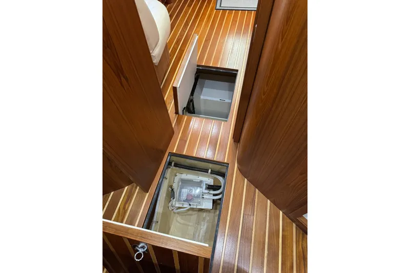 Slide: The Image of 2007 Tiara 43 yacht interior with open floor compartments revealing equipment. - 13